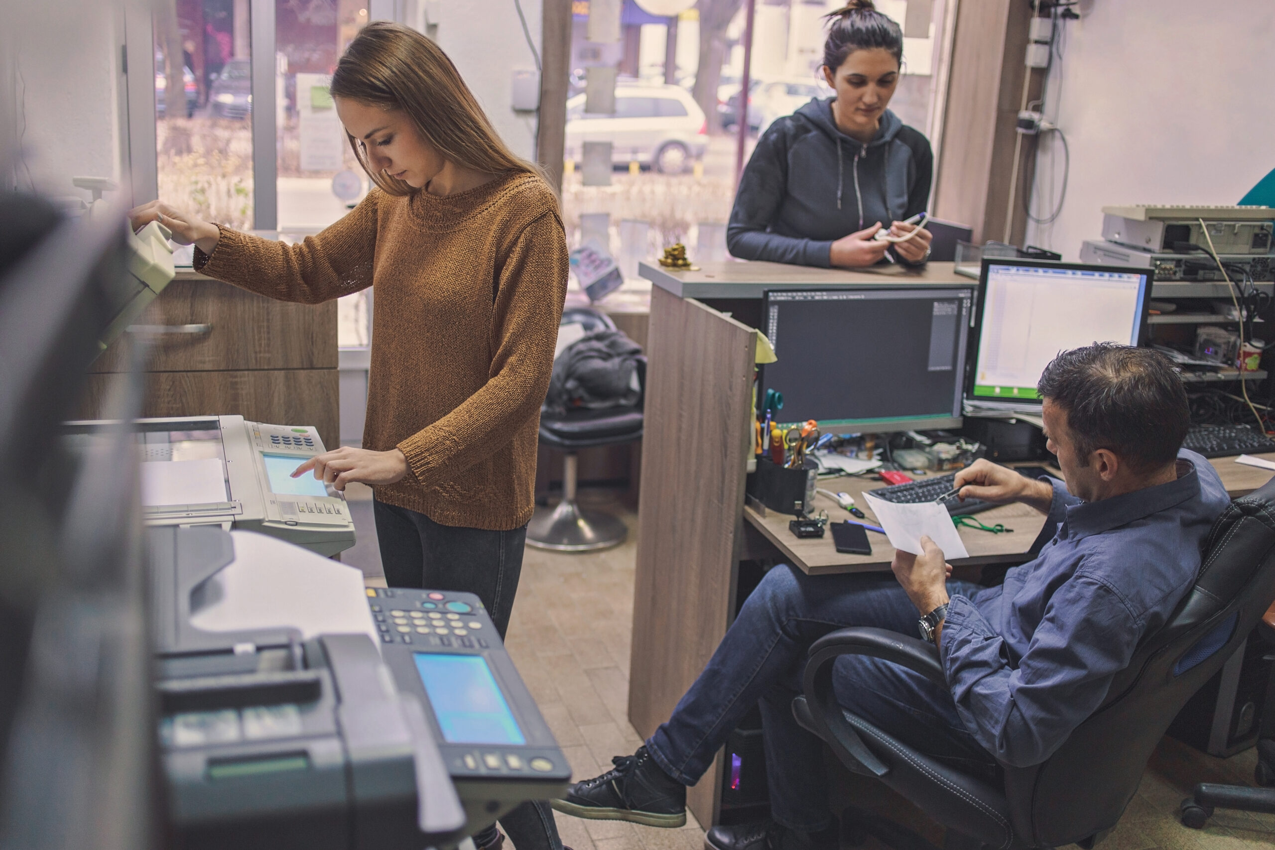Woman and man working in printing centar
